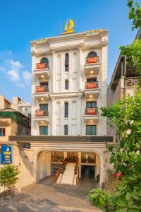 a large white building with steps leading up to it at Hanoi Sail Hotel in Hanoi