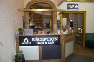 a sign for the reception of a hotel and cafe at Ambrose House & Cafe - SELF CHECK-IN GUESTHOUSE in Montreal