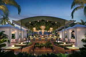 an outdoor dining area with tables and chairs at The Nora Hotel in West Palm Beach