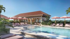 a pool with chairs and umbrellas at a resort at The Nora Hotel in West Palm Beach +8 photos