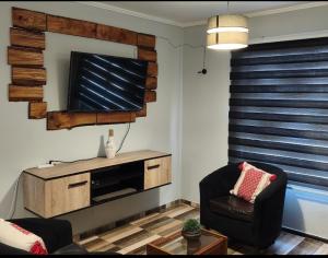 a living room with a flat screen tv on a wall at Guacolda Coquimbo in Coquimbo