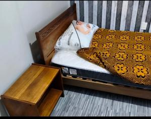 a doll laying on a bed next to a table at Guacolda Coquimbo in Coquimbo