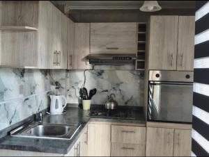 a kitchen with a sink and a stove top oven at Guacolda Coquimbo in Coquimbo