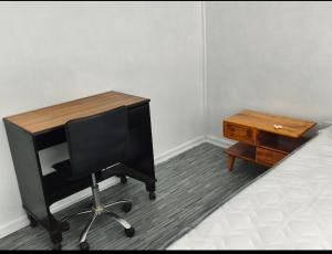 a desk with a computer on a bed next to a table at Guacolda Coquimbo in Coquimbo