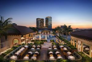 an aerial view of a resort with tables and chairs at The Nora Hotel in West Palm Beach