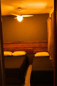 two beds in a room with a ceiling fan at Casas 2 Terrace in Laguna