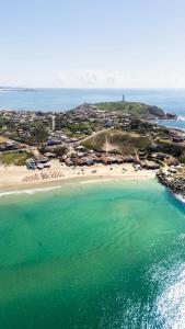 an aerial view of a beach with people in the water at Casas 2 Terrace in Laguna +15 photos