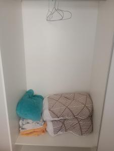 a closet with two pillows and a bed at Apartamento próximo arena mrv, expominas e Puc in Belo Horizonte +20 photos