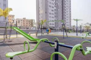 a playground with green swings in a park at Apartamento próximo arena mrv, expominas e Puc in Belo Horizonte