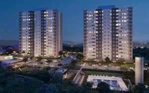 a view of two tall buildings at night at Apartamento próximo arena mrv, expominas e Puc in Belo Horizonte