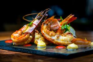 a plate of food with shrimp on a table at Apótek Hotel Reykjavík by Keahotels in Reykjavík