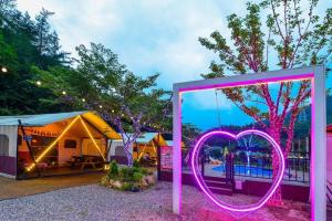 a marquee with a heart sign in front of a tent at Gapyeong Gratia glamping in Gapyeong