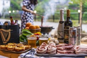 a table with a bunch of food and bottles of wine at Gapyeong Gratia glamping in Gapyeong