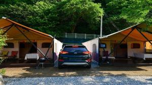 a car parked in front of some tents at Gapyeong Gratia glamping in Gapyeong +28 photos