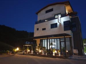a large building with lights in front of it at night at Gosung Shine House in Goseong