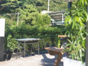 a picnic table and benches in a park at Gosung Shine House in Goseong +9 photos