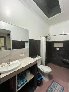 a bathroom with a sink and a toilet at Bulkan Villa Rental in General Luna