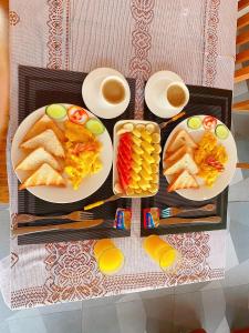 a tray of food with plates of food and drinks at Elephant Hotel Luang Parabang in Luang Prabang