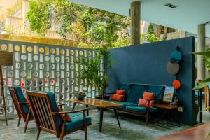 a patio with a blue couch and a table and chairs at Sonitori Boutique Resort in Phnom Penh