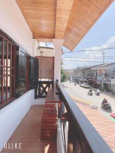 a balcony of a building with a view of a street at Elephant Hotel Luang Parabang in Luang Prabang +15 photos
