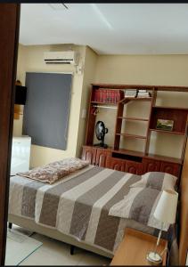 a bedroom with a bed and a chalkboard in it at Suíte mobiliada Duo Mio in Paragominas