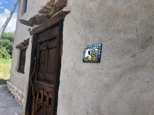 a building with a door with a mosaic on it at Hidden house in La Fronterita de Amaicha in Amaicha del Valle +15 photos
