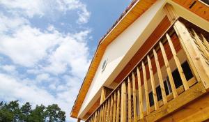 a building with a wooden railing on the side of it at Samcheok lime pension in Samcheok