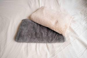 a towel is sitting on top of a bed at REKADO ROOM Shinsuizenji 3C in Kumamoto