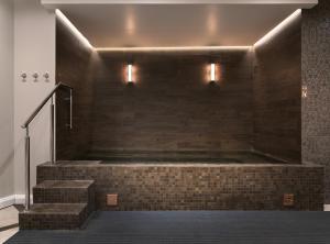 a bathroom with a brick wall and stairs with lights at Hotel Borg by Keahotels in Reykjavík +74 photos