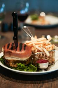 a plate of food with a sandwich and french fries at Hotel Katla by Keahotels in Vík