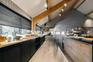 a large kitchen with a long counter in a restaurant at Hotel Katla by Keahotels in Vík