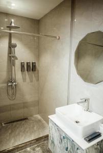 a bathroom with a sink and a shower at Singala Hotel Ulaanbaatar in Ulaanbaatar +52 photos