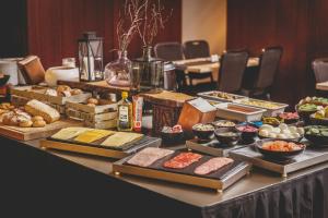 a table with many different types of bread and pastries at Hotel Kea by Keahotels in Akureyri