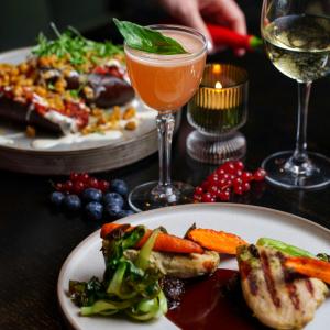 a table with two plates of food and a drink at Hotel Kea by Keahotels in Akureyri