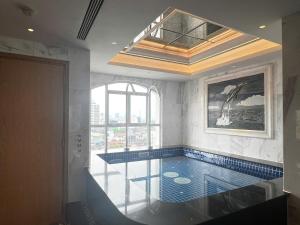 a swimming pool in a room with a window at Silk Path Hotel Hanoi in Hanoi +31 photos