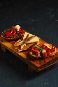 a wooden cutting board with two slices of bread and fruit at Kantary Hotel Banchang in Ban Chang +53 photos