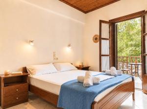 a bedroom with a bed and a large window at Elias Studio & Apartment near Papa Nero Beach Pelion in Agios Ioannis Pelio