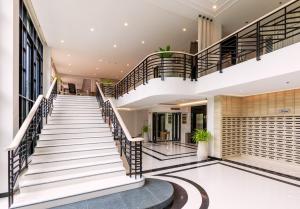 a view of the lobby of a building with stairs at Kantary Hotel Banchang in Ban Chang