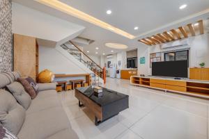 a living room with a couch and a television at Jialai Homestay - Parking Available - Near Magong Center in Magong
