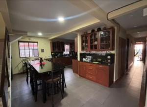 a kitchen with a table and a dining room at Habitaciones Casa Cuscatlan in Tamanique