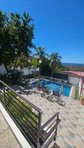 a patio with a table and chairs and a pool at Habitaciones Casa Cuscatlan in Tamanique