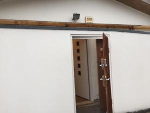 an open door to a building with a sign on it at The Bungalow in London +5 photos