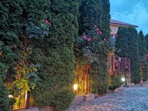 a building covered in plants and flowers on a street at Vila Casa Esy in Eforie Nord