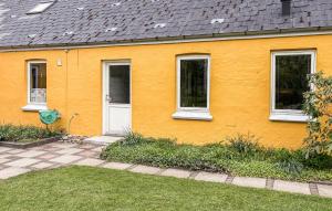 a yellow house with a white door and windows at Stunning Apartment In Holstebro With Wifi in Holstebro