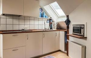 a kitchen with white cabinets and a window at Stunning Apartment In Holstebro With Wifi in Holstebro