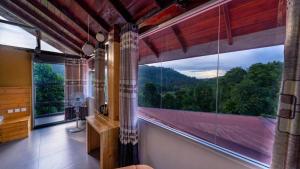 a bathroom with a large window with a mountain view at 3 Arch Resort Ella in Ella