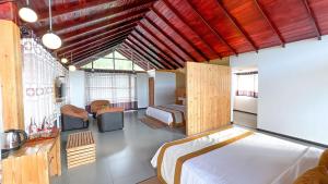 a bedroom with a large bed and a room with a bed sqor at 3 Arch Resort Ella in Ella