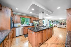 a large kitchen with wooden cabinets and a large island at Forest house 4 bedrooms in Surrey