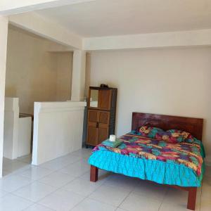 a bedroom with a bed and a cabinet in it at Pondok Diana 3 in Jasri