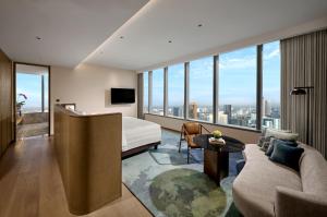 a hotel room with a bed and a couch at Pan Pacific Jakarta in Jakarta